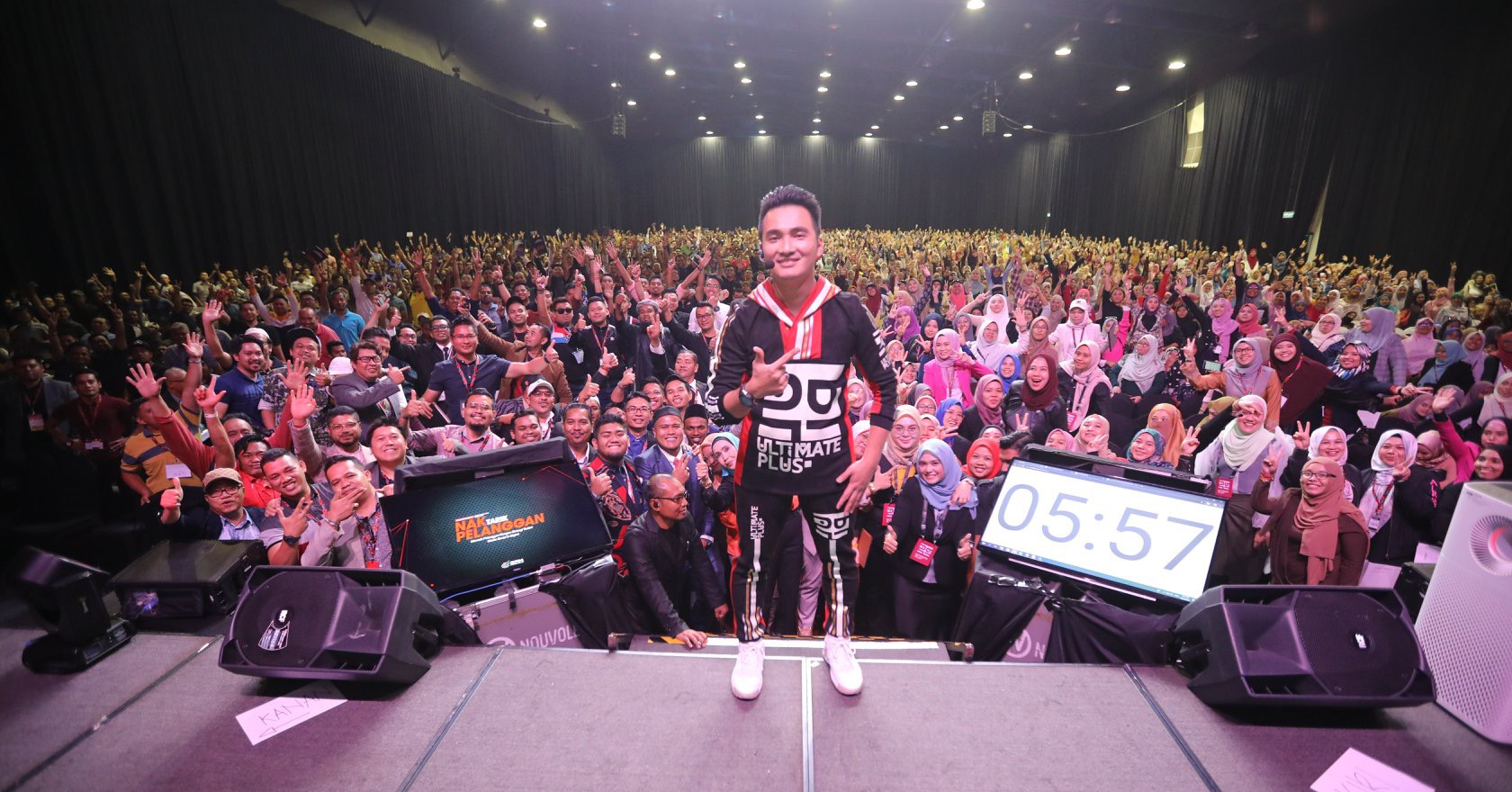 Najib Asaddok on stage with participants at a training programme